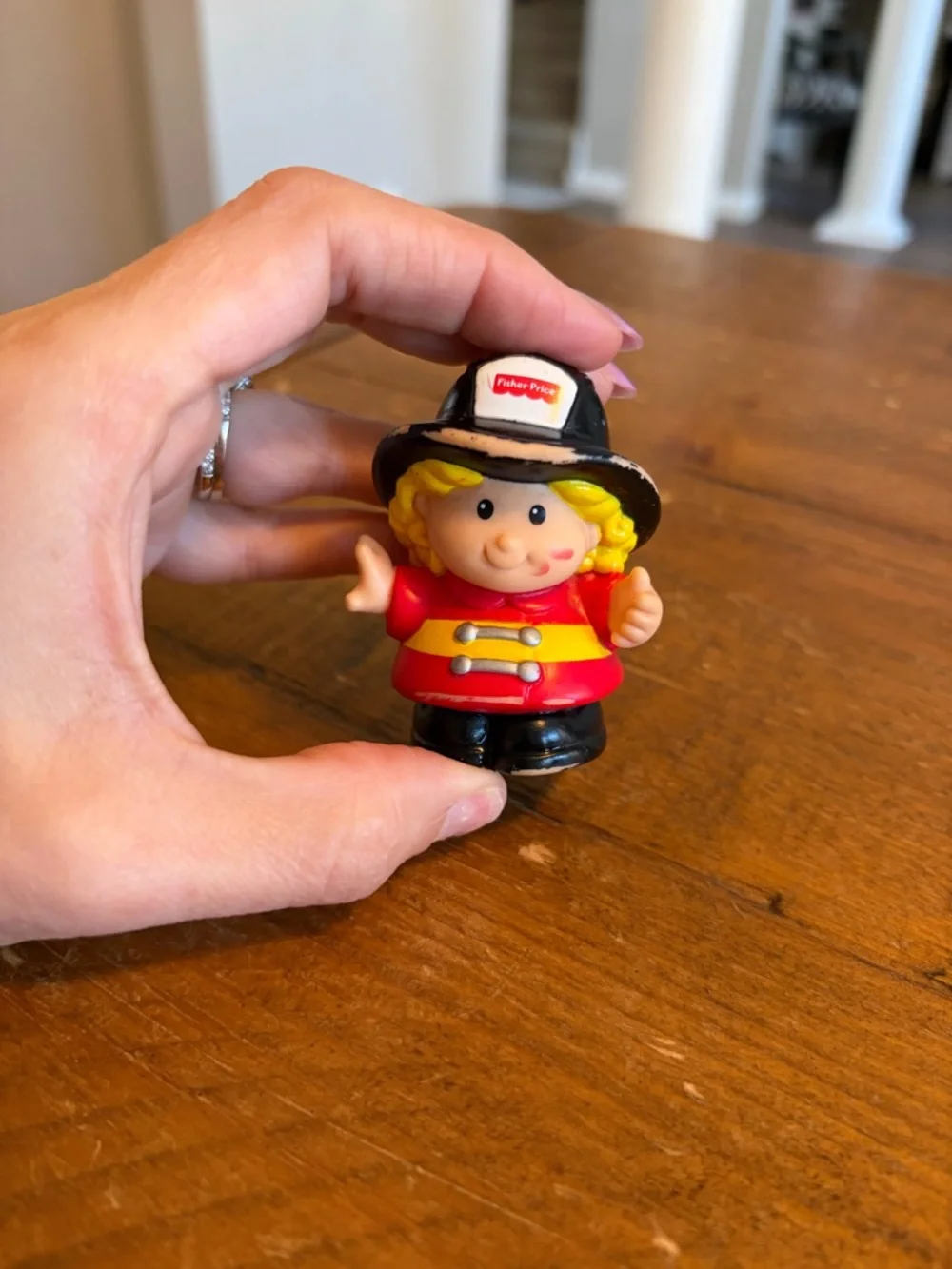 Fisher Price Little People firefighter as is. Has paint wear around hat
